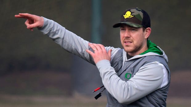 New Oregon offensive coordinator and quarterbacks coach Will Stein leads a drill on the first practice of spring for Oregon f