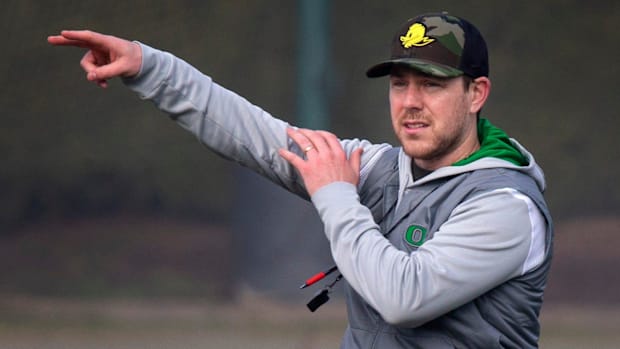New Oregon offensive coordinator and quarterbacks coach Will Stein leads a drill on the first practice of spring for Oregon f