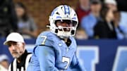 Nov 8, 2025; Chapel Hill, North Carolina, USA; North Carolina Tar Heels quarterback Gio Lopez (7) looks to pass as Stanford Cardinal safety Scotty Edwards (21) defends in the second quarter at Kenan Stadium. Mandatory Credit: Bob Donnan-Imagn Images