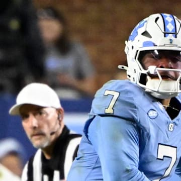 Nov 8, 2025; Chapel Hill, North Carolina, USA; North Carolina Tar Heels quarterback Gio Lopez (7) looks to pass as Stanford Cardinal safety Scotty Edwards (21) defends in the second quarter at Kenan Stadium. Mandatory Credit: Bob Donnan-Imagn Images