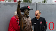 John Cook gets the first look at his new statue while shaking the hand of sculptor George Lundeen. Cook was laughing that Lundeen had snuck a cowboy hat onto the statue after the idea was nixed earlier.