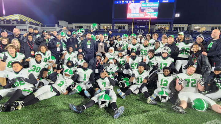 The Arundel football team celebrates its 2024 MPSSAA Class 3A state championship on the turf at Navy-Marine Corps Stadium following its 35-7 win over Linganore in the title game. It was the first football state championship for the Wildcats since 1975.