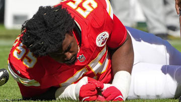Oct 19, 2025; Kansas City, Missouri, USA; Kansas City Chiefs defensive tackle Omarr Norman-Lott (55) is checked on by a trainer after an injury against the Las Vegas Raiders during the third quarter of the game at GEHA Field at Arrowhead Stadium.