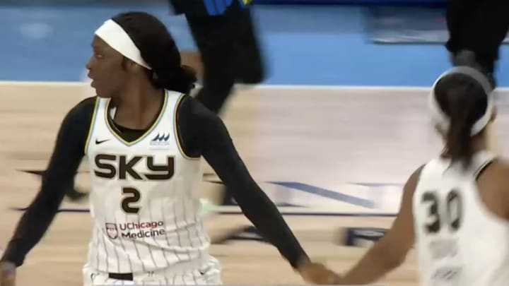 Kahleah Copper gets a high five from teammate Azurá Stevens as Chicago took a 45-32 lead over the Dallas Wings Friday night.