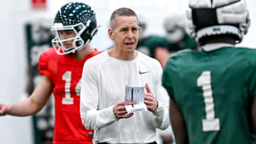 Michigan State's offensive coordinator Jay Johnson, left, talks with Jayden Reed during practice on Tuesday, March 29, 2022, at the indoor football facility in East Lansing.
