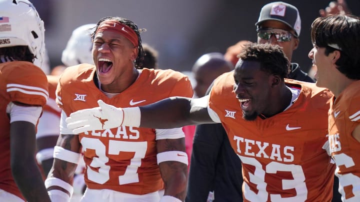 Texas Longhorns wide receiver Xavier Worthy (1) celebrates with Texas Longhorns linebacker David Gbenda (33) and Texas Longhorns linebacker Morice Blackwell Jr. (37) in the second quarter of an NCAA college football game, Saturday, November. 4, 2023, in Austin, Texas.