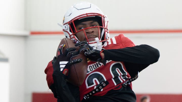 Louisville football Tayon Holloway (20) runs drills during spring practice on Saturday, March 23, 2024 at the Trager practice facility in Louisville, Ky.