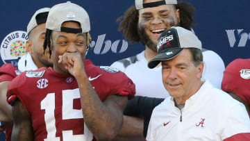 Alabama defensive back Xavier McKinney (15) laughs as Head Coach Nick Saban strikes a pose with his