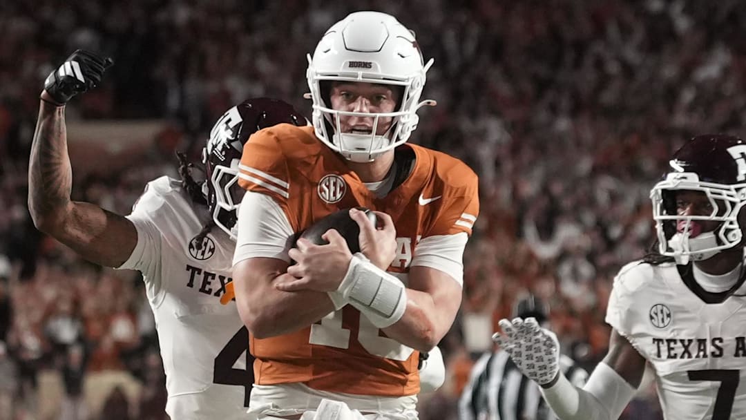 Texas Longhorns quarterback Arch Manning keeps the ball and runs for a touchdown during the second half against the Texas A&M Aggies at Darrell K Royal-Texas Memorial Stadium. 