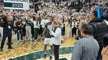Michigan State head coach Tom Izzo and guard Tre Holloman celebrate the Spartans' Big Ten championship.