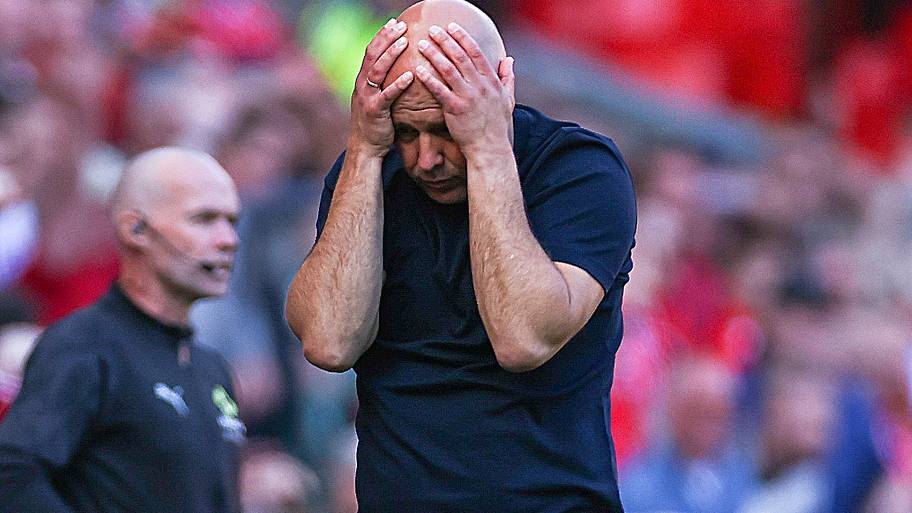 Arne Slot covering his face.