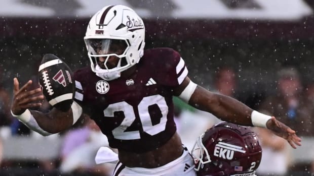  Mississippi State Bulldogs running back Johnnie Daniels loses the ball as he is tackled by an Eastern Kentucky defender.