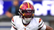 Washington Commanders quarterback Jayden Daniels runs against the Los Angeles Chargers.