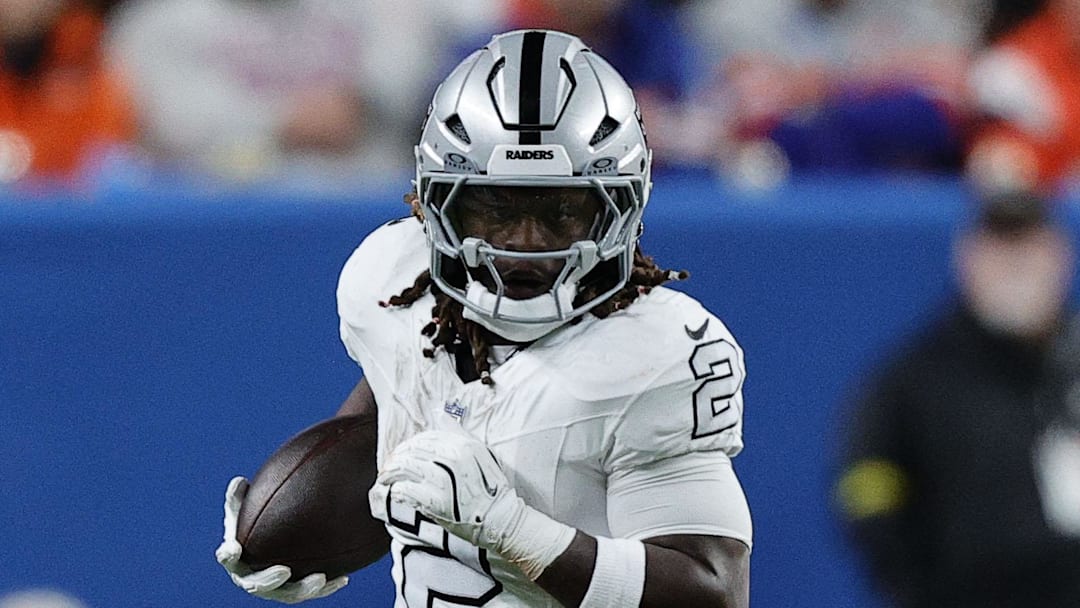 Nov 6, 2025; Denver, Colorado, USA; Las Vegas Raiders running back Ashton Jeanty (2) rushes the ball against the Denver Broncos during the first half at Empower Field at Mile High. Mandatory Credit: Isaiah J. Downing-Imagn Images