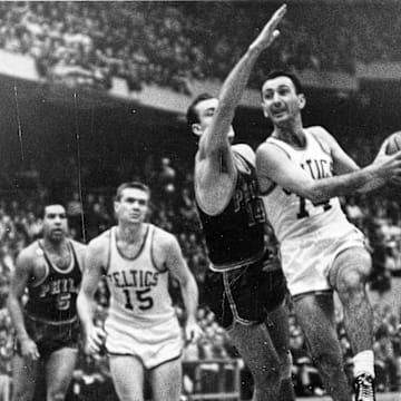 1962; FILE PHOTO;  In a 1962 playoff game against Philadelphia, Tommy Heinsohn (15) is about to receive a pass from Bob Cousy, a fellow Holy Cross graduate. Mandatory Credit: Telegram & Gazette-USA TODAY NETWORK 