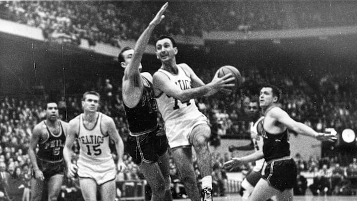 1962; FILE PHOTO;  In a 1962 playoff game against Philadelphia, Tommy Heinsohn (15) is about to receive a pass from Bob Cousy, a fellow Holy Cross graduate. Mandatory Credit: Telegram & Gazette-USA TODAY NETWORK 