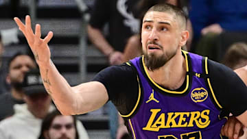 Former Los Angeles Lakers center Alex Len (27) reaches for the ball against Milwaukee Bucks center Jericho Sims (00) in the second quarter at Fiserv Forum.
