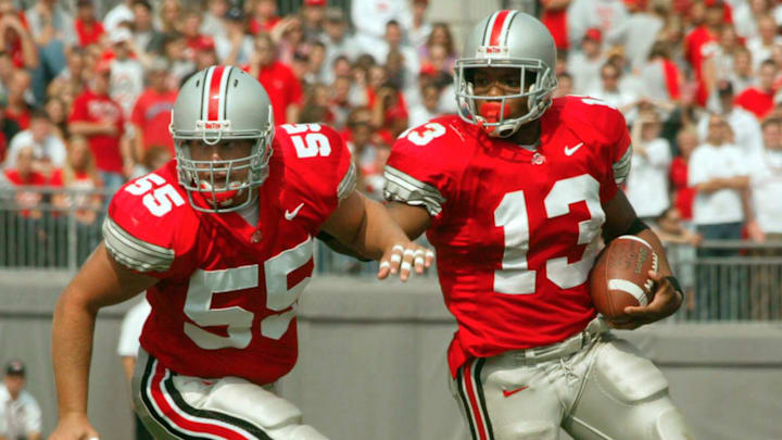 (OSUIU LAURON 28SEP02) Ohio State Buckeyes Maurice Clarett (cq) 13, uses teammate Nick Mangold (cq) 55, to clear the way and open up a hole in the first quarter against the Indiana Hoosiers at the Ohio Stadium, September 28, 2002. (Dispatch photo by Neal C. Lauron)

Ncl Osuiu 10