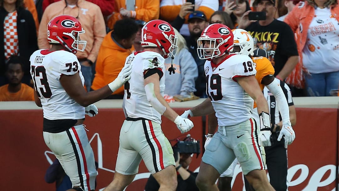 Nov 18, 2023; Knoxville, Tennessee, USA; Georgia Bulldogs tight end Brock Bowers (19) celebrates after scoring a touchdown against Tennessee Volunteers defensive back Jaylen McCollough (2) during the first half at Neyland Stadium. Mandatory Credit: Randy Sartin-Imagn Images