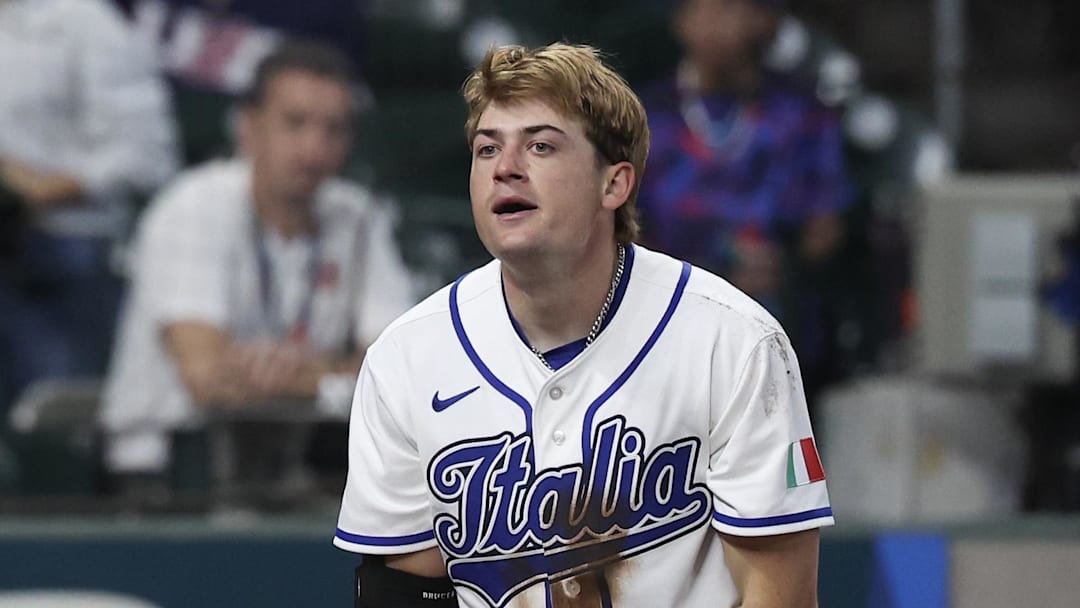 Mar 8, 2026; Houston, TX, United States;  Italy right fielder Zach Dezenzo (4) is safe at home plate as Great Britain catcher Harry Ford (1) drops the ball after Dezenzo hit a triple and scored on a throwing error in the fifth inning at Daikin Park. Mandatory Credit: Thomas Shea-Imagn Images