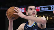 Memphis Grizzlies center Zach Edey spins to the basket as Portland Trail Blazers center Yang Hansen defends