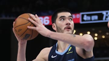 Memphis Grizzlies center Zach Edey spins to the basket as Portland Trail Blazers center Yang Hansen defends