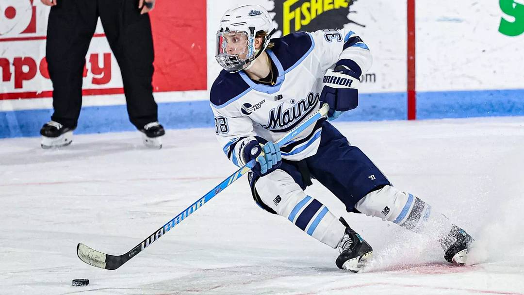 Maine Black Bear forward Oskar Komarov skates with the puck.
