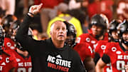 Nov 4, 2023; Raleigh, North Carolina, USA; North Carolina State Wolfpack head coach Dave Doeren (center) lead his team onto the field prior to a game against the Miami Hurricanes at Carter-Finley Stadium. Mandatory Credit: Rob Kinnan-Imagn Images