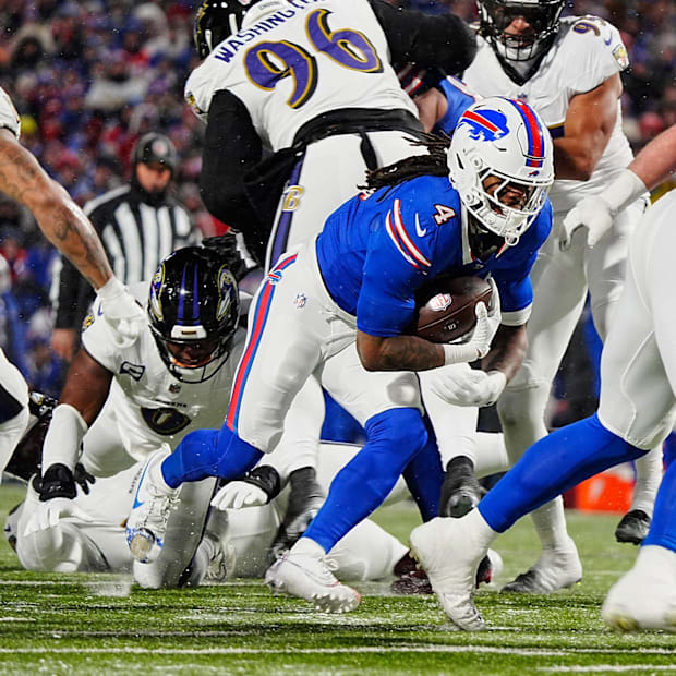 James Cook, carrying the ball, keeps low 