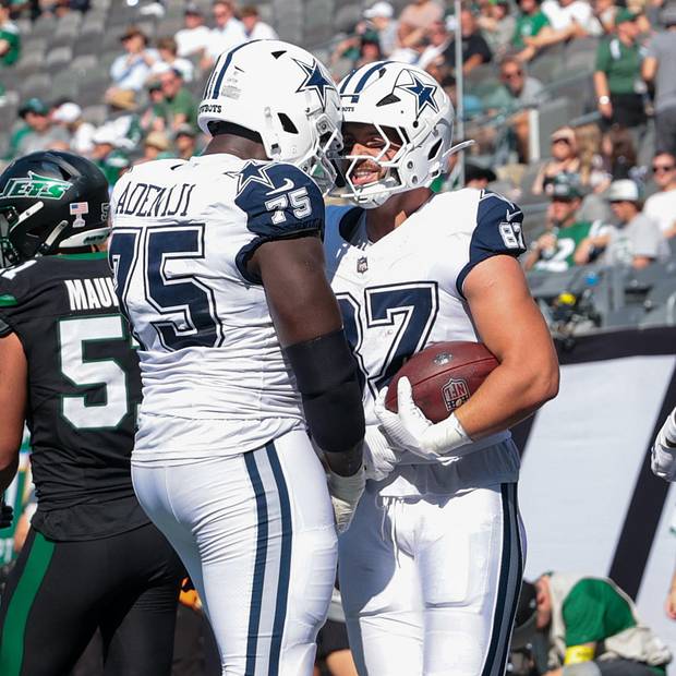 Dallas Cowboys tight end Jake Ferguson reacts in the end zone with offensive tackle Hakeem Adeniji after his second touchdown