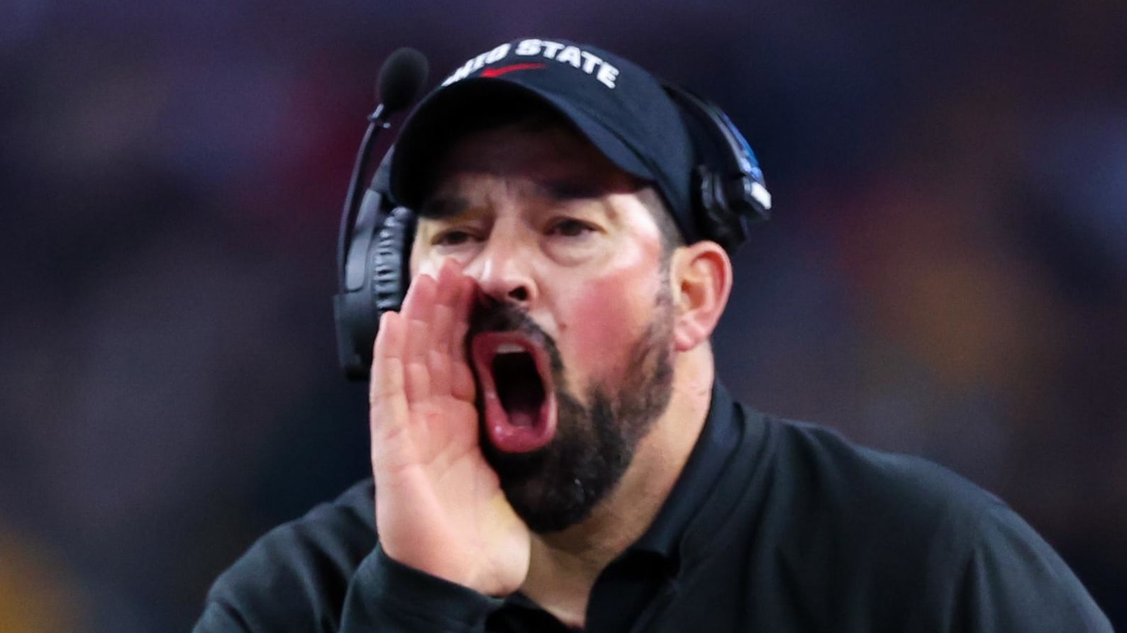Ohio State Buckeyes head coach Ryan Day working on the sideline during a college football game in the Big Ten.