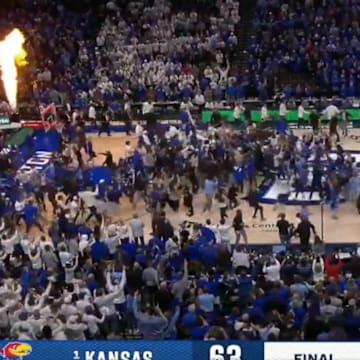 Creighton fans storm the court after the Blue Jays beat Kansas.