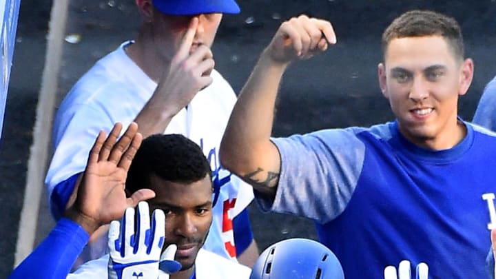 Dodgers left fielder Cody Bellinger (35) is greeted in the dugout by right fielder Yasiel Puig (66), catcher Austin Barnes (15) and starting pitcher Clayton Kershaw (22) after a solo home run in the first inning of the game against the Cincinnati Reds at Dodger Stadium.
