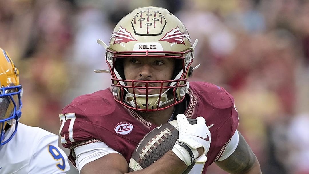 Oct 11, 2025; Tallahassee, Florida, USA; Florida State Seminoles running back Gavin Sawchuk (27) runs the ball past Pittsburgh Panthers linebacker Kyle Louis (9) during the first half at Doak S. Campbell Stadium. Mandatory Credit: Melina Myers-Imagn Images
