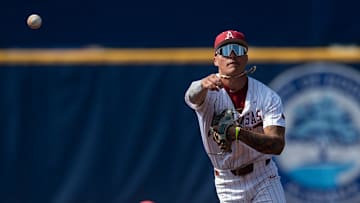 Arkansas Razorbacks' Wehiwa Aloy (9) throws the ball to first base as Arkansas Razorbacks take on Ole Miss Rebels during the SEC baseball tournament at Hoover Met in Birmingham, Ala., on Friday, May 23, 2025. Ole Miss Rebels defeated Arkansas Razorbacks 5-2.