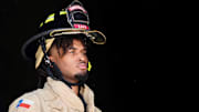 Sep 16, 2025; San Antonio, Texas, USA; San Antonio Spurs guard Stephon Castle (5) dons bunker gear during a fire safety demonstration in San Antonio in partnership with USAA.
