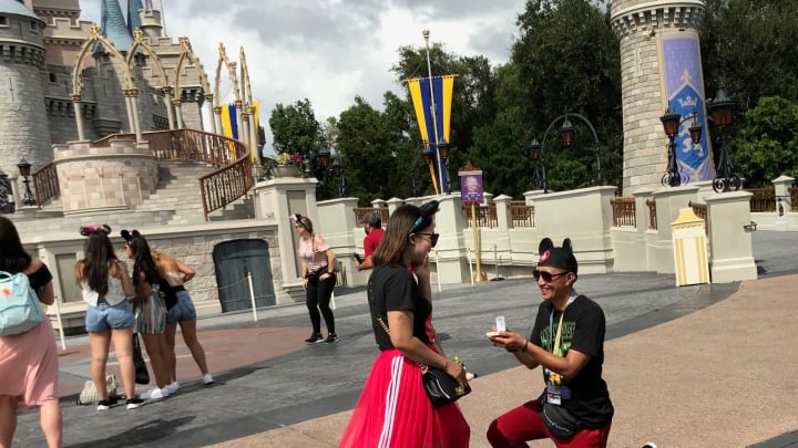 She said yes: A proposal, complete with mouse ears, in front of Cinderella Castle on Aug. 31, 2019.