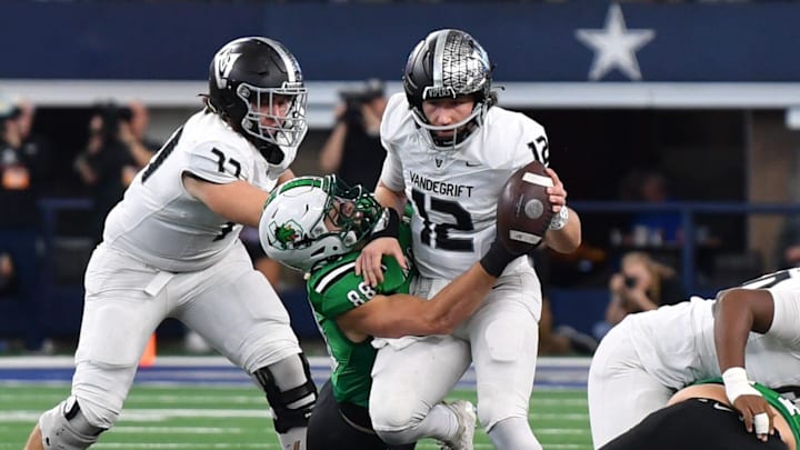 Southlake Carroll's Cody Williford tackles Austin Vandegrift's Miles Teodecki during the 6A DII UIL Texas State Football Championship game on Saturday, December 21, 2024, at AT&T Stadium in Arlington.