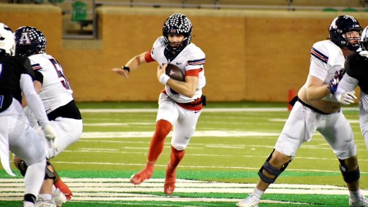 Allen quarterback Jeremiah Daoud runs through an opening for a first down in a Class 6A Division I playoff game against North Crowley on Friday in Denton.