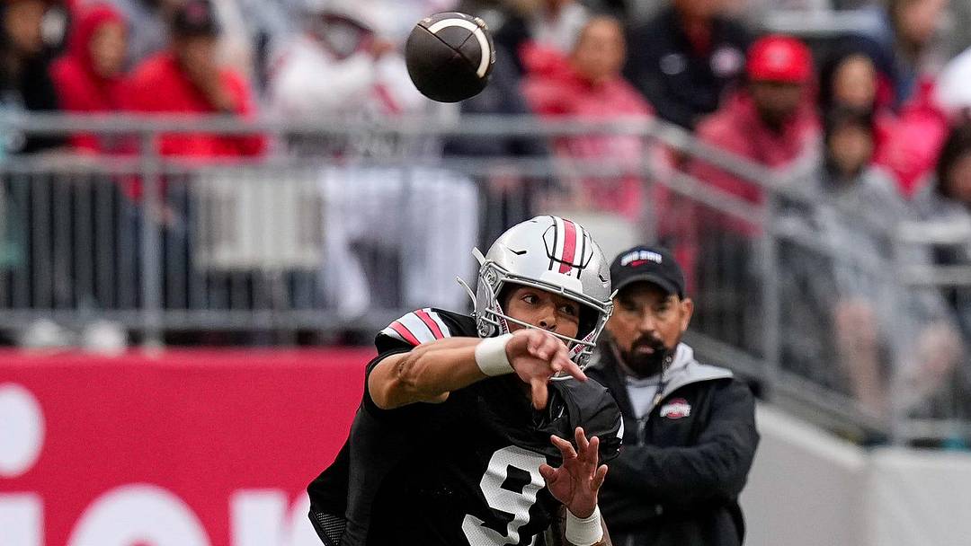 Quarterback Tavien St. Clair (9) makes a pass as head coach Ryan Day watches in the background in the second half of the Ohio State football spring game at Ohio Stadium on Saturday, April 18, 2026 in Columbus, Ohio.