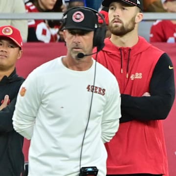 Jan 5, 2025; Glendale, Arizona, USA;  San Francisco 49ers quarterback Brock Purdy (right) and head coach Kyle Shanahan (left) look on the in second half against the Arizona Cardinals at State Farm Stadium. Mandatory Credit: Matt Kartozian-Imagn Images