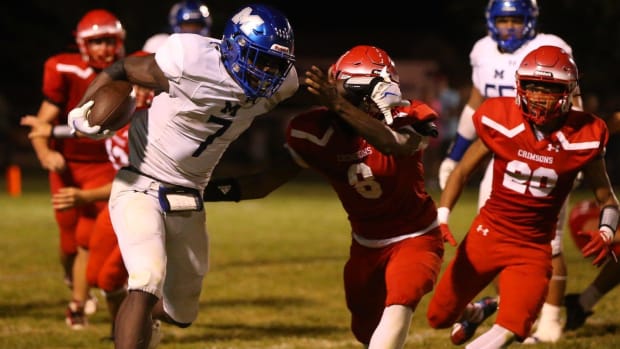 Decatur MacArthur freshman Myson Johnson-Cook runs against Jacksonville in an Illinois high school football game in 2023.