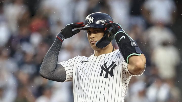 Jun 22, 2024; Bronx, New York, USA;  New York Yankees designated hitter Giancarlo Stanton (27) gestures after hitting a double against the Atlanta Braves in the fourth inning at Yankee Stadium. 