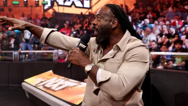 Booker T grabs a microphone during an episode of WWE NXT.