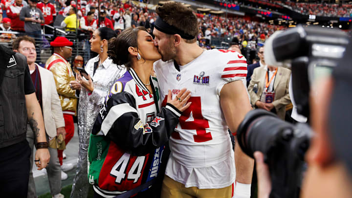 Kyle Juszczyk kisses his wife, Kristin Juszczyk, during pregame warmups before Super Bowl LVIII against the Kansas City Chiefs at Allegiant Stadium in 2024.