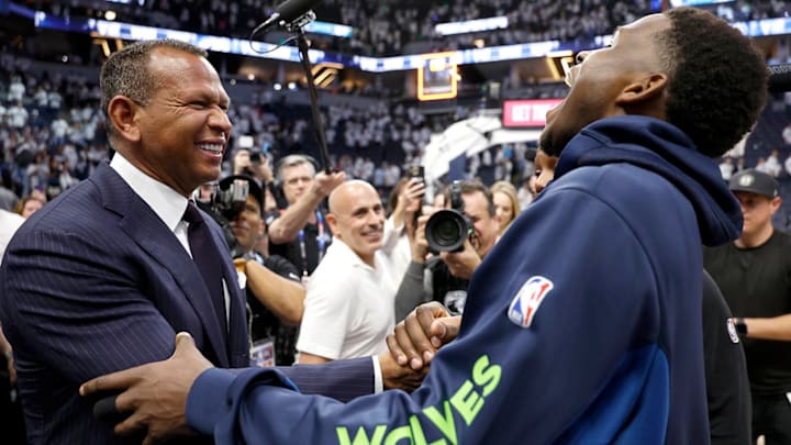 Alex Rodriguez shakes hands with Anthony Edwards during a playoff game in 2024.