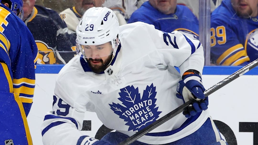 Mar 14, 2026; Buffalo, New York, USA;  Buffalo Sabres defenseman Logan Stanley (64) misses his check as Toronto Maple Leafs center Bo Groulx (29) looks to control the puck during the first period at KeyBank Center. Mandatory Credit: Timothy T. Ludwig-Imagn Images