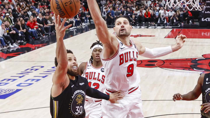 Jan 15, 2023; Chicago, Illinois, USA; Golden State Warriors guard Stephen Curry (30) goes to the basket against Chicago Bulls center Nikola Vucevic (9) during the second half of an NBA game at United Center. 