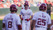 Brent Iredale with Cam Kozeal and Kuhio Aloy after hitting his seventh home run of the year against the Central Arkansas Bears. The Razorbacks won 9-2.