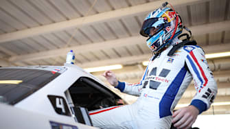 Connor Zilisch, driver of the No. 88 WeatherTech Chevrolet, enters his car in the garage area at Phoenix Raceway.